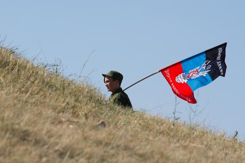 НМ ДНР выложила видео, на котором военный республики водружает ее флаг на самой высокой точке Мариуполя — городской телебашне 