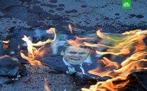 На площади имени Ленина в Симферополе сожгли портреты Трампа, Макрона и Мэй